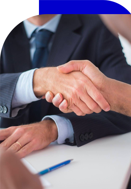 Two individuals, possibly a staff member and a client, shaking hands in a gesture of agreement or partnership.
